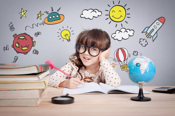 education concept, cute little happy girl at school making homework with creativity
