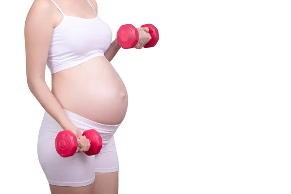 Pregnant exercises concept.A portrait of a Beautiful asian pregnant woman doing light exercise by using dumbbell isolated on white background with clipping path. rosto anônimo Ásia feminino em seus 20 anos — Fotografia de Stock