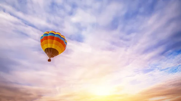 Colorful hot air balloon flying over the sky as background at sunrise Royalty Free Stock Photos