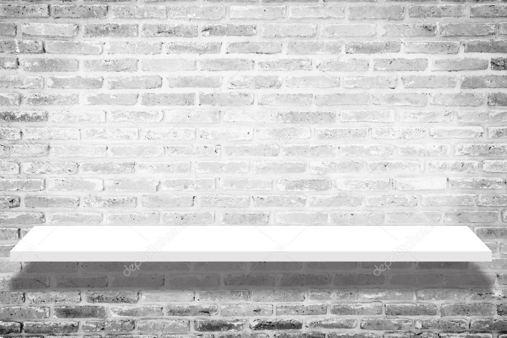 empty white shop shelf with shadow , retail shelf on brick vintage wall room background. white shelf isolated on brick background. shelf mockup