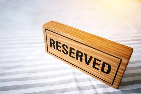 reserved table. reserved wooden sign on table for reservation placed. reserved table in the restaurant.