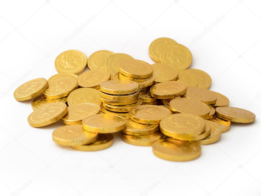 close up a pile of golden coins isolated on white background
