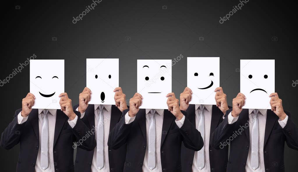 five businessman holding a card with drawing facial expressions different emotion feelings face on white paper