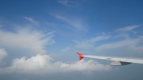 4K映像 飛行機で旅行する 飛行機の窓から見る空に翼の飛行機と雲 — ストック動画