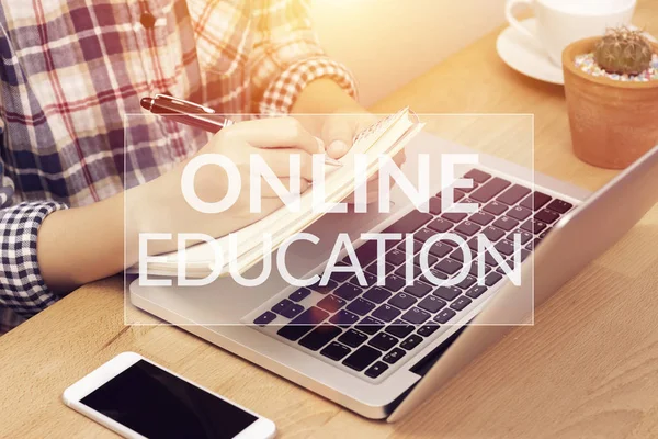 Online learning course concept. student using computer laptop for training online and writing lecture note in notebook with text online education on top layer. distance education — Stock Photo, Image