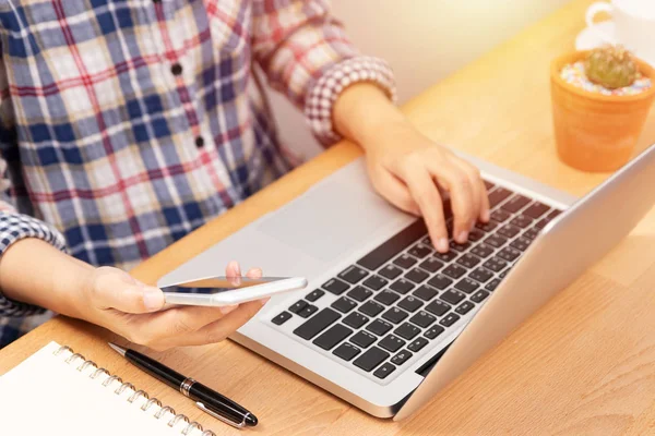 People working from home using smart phone and notebook laptop computer at workplace, anonymous face. internet marketing concept — Stock Photo, Image