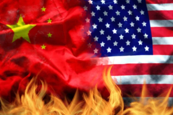 Waving USA and China flag with fire on foreground. serious trade tension or trade war between US and China, financial concept — Stock Photo, Image