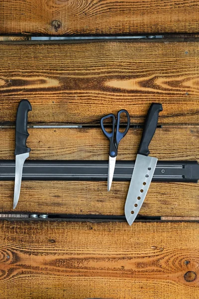 Magnetic knife holder on a wooden wall — Stock Photo, Image