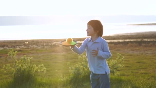 幸福的家庭在自然 妈妈和儿子扔球 家庭享受日落 — 图库视频影像