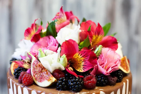A cake as a birthday present with berry and flowers