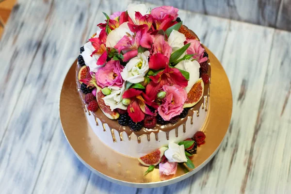 A cake as a birthday present with berry and flowers