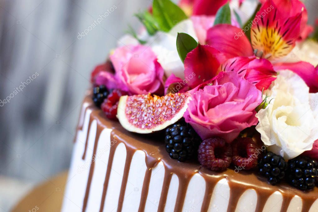 A cake as a birthday present with berry and flowers