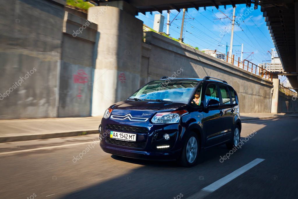 Citroen Picasso cars under a bridge in Kiev near the Dnipro river, Ukraine