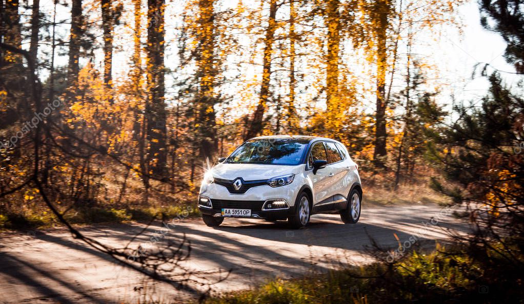 Cars white Renault Captur in autumn in mountainous area, Ukraine