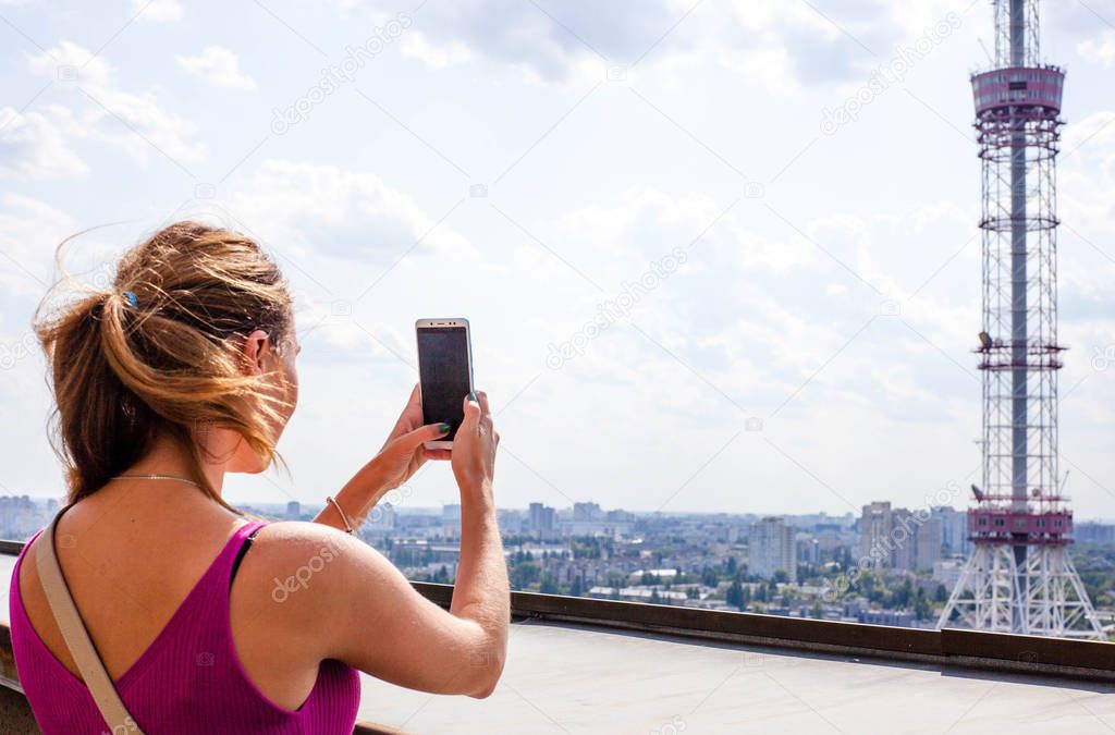 Girl photographing a panorama of Kiev, Ukraine