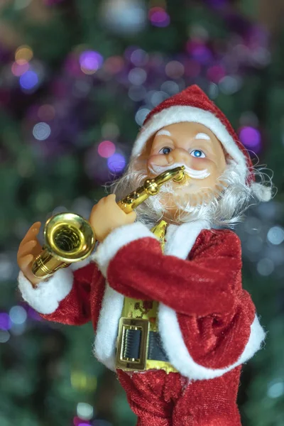 A portrait of a Santa Claus who plays the trumpet