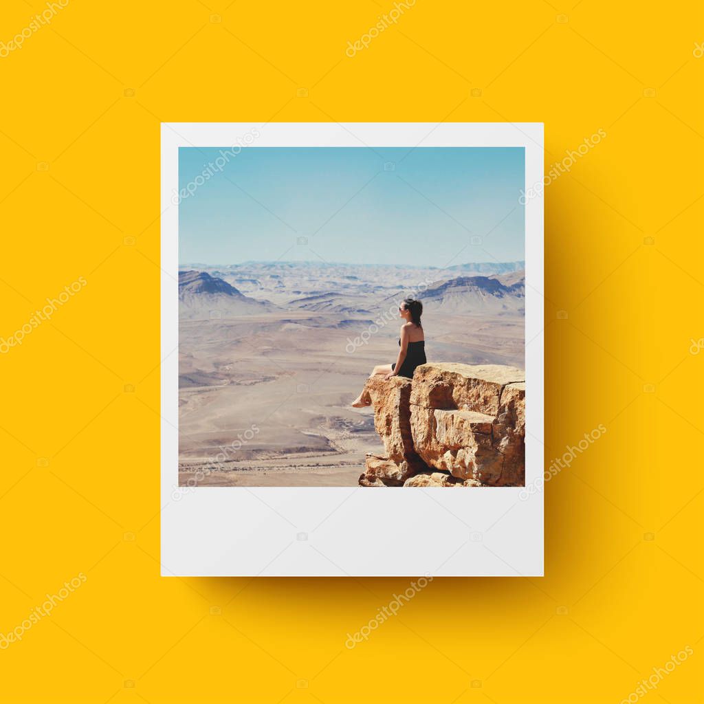 Instant Photo card on yellow background. Girl looking on desert Negev in Israel. Postcard, travel concept