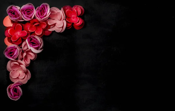 Frame of flowers on black background. Valentine s Day. Greeting. Flatlay