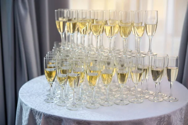 Champagne glasses standing on round table at the event party