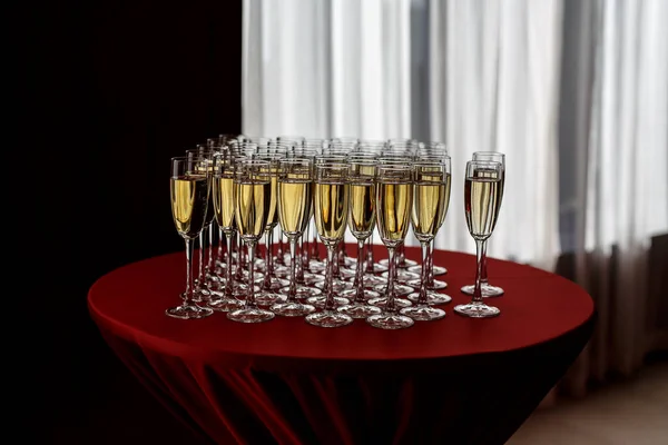 Champagne glasses standing on round table at the event party