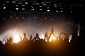 Картина, постер, плакат, фотообои "concert hall with a lit stage and people silhouettes during a concert.", артикул 378242296