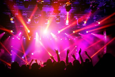 People, crowd on concert. Purple light from stage clipart