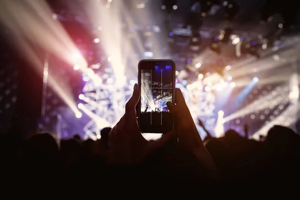 Photo for social network at concert. Mobile phone on music show