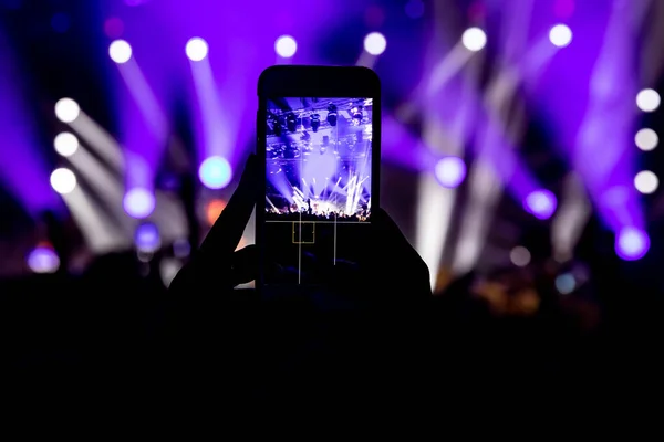 Social media photo to mobile phone. Concert light performance