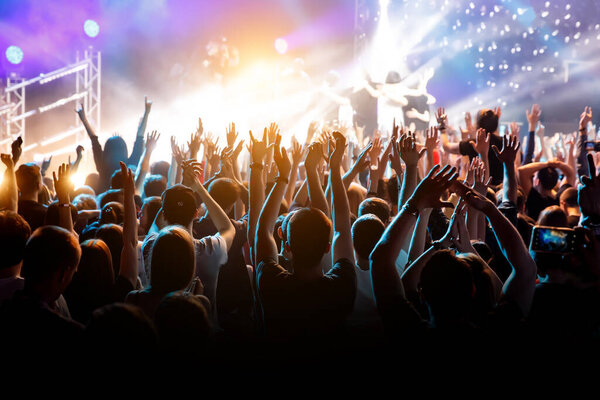 Crowd with raised hands on music concert.