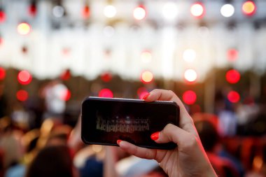 Açık hava müzik festivalinde cep telefonu kullanmak.