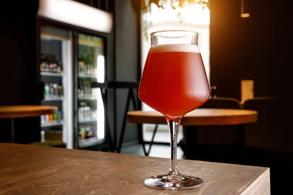 Beer glass in bar interior. Craft in pub