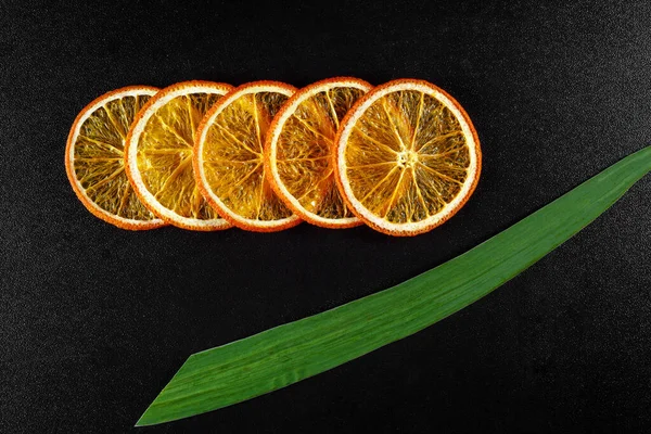 Pieces of dried orange on a black background