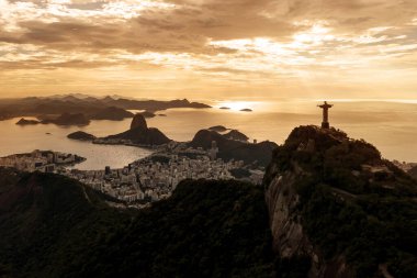 Rio de Janeiro, Brazil - 23.11.2019: Aerial view of Rio de Janeiro with Christ Redeemer and Corcovado Mountain. Morning orange dawn light clipart