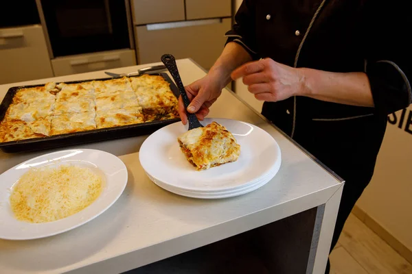 Cook Puts Piece Fresh Lasagna White Plate — Stock Photo, Image