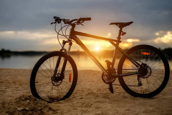 Sylwetka sportowego roweru na plaży. Zachód słońca. — Zdjęcie stockowe