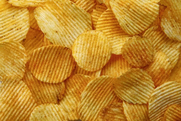 Corrugated Potato Chips. Food background. Top view.