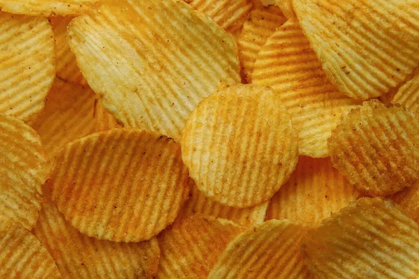 Corrugated Potato Chips. Food background. Top view. — Stock Photo, Image
