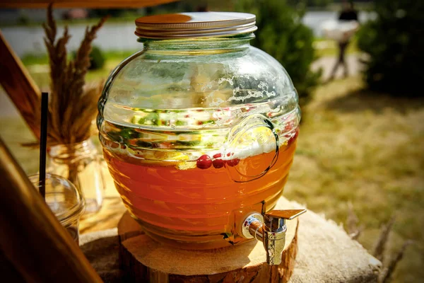 Jugs of lemonade at the summer outdoor party. — Stock Photo, Image