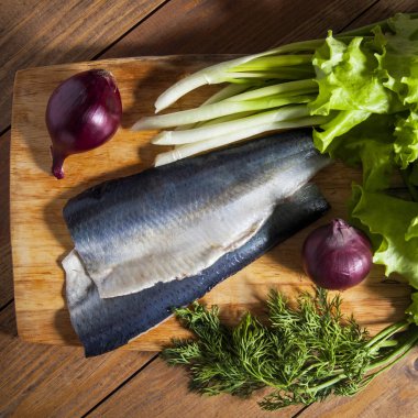 Soğan, marul ve dereotu ile ringa balığı filetosu. Kare için kırpılmış.