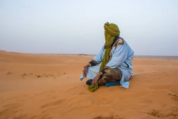 lonely Arab man in Sahara Desert, near Merzouga, Morocco