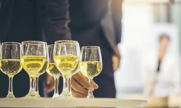 cropped shot of business partners drinking white wine