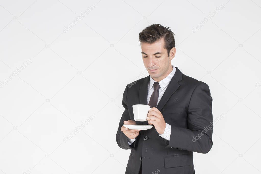 Young businessman drinking tea or coffee