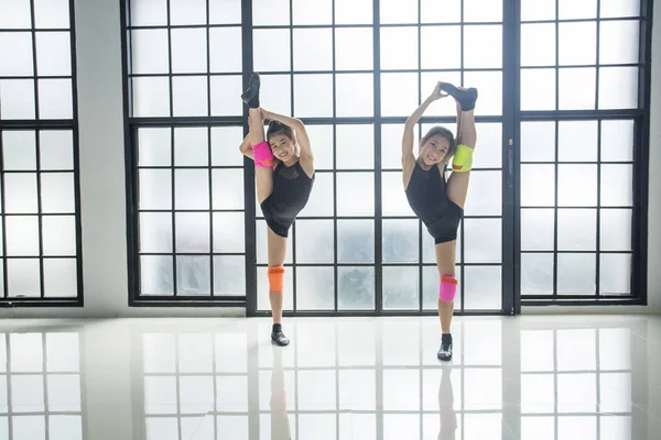 Two young girl dancers practicing modern dance practice in the classroom. and on training together performing emotional contemporary dance in studio