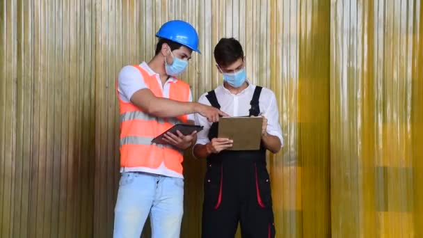 Male Factory Worker Mechanic Talking Each Other Holding File Inspecting — Stock Video