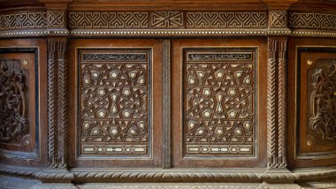 Two arabesque sashes of an old mamluk era cupboard with geometrical decorations, Zeinab Khatoon historic house, Cairo, Egypt clipart