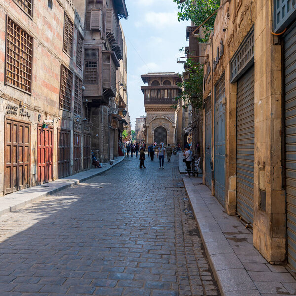 Cairo, Egypt- June 26 2020: Moez Street with few local visitors and Sabil-Kuttab of Katkhuda Mamluk era historic building at the far endduring Covid-19 lockdown period, Gamalia district, Old Cairo