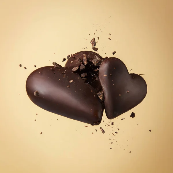 Two Chocolate Heart Beige Background Hearts Collide Break Crumbs High — Stock Photo, Image