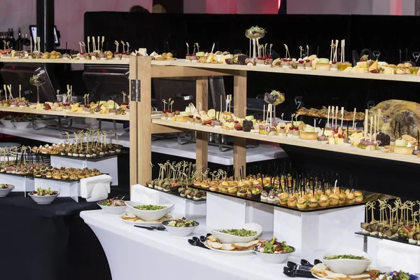 Banquet buffet with snacks delicacies cheese canapes desserts.