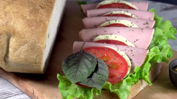 Sandwich from the traditional Ukrainian eco bread lost to taste without flavors, fillers and GMOs. Baked in the oven on the wood of fruit trees. — Stock Footage Sandwich Traditional Ukrainian Eco Bread Lost Taste Flavors Fillers Gmos Royalty Free Stock Video
