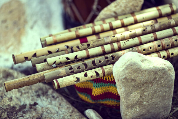 Musical Instrument India against the background of traditional shawls close-up.